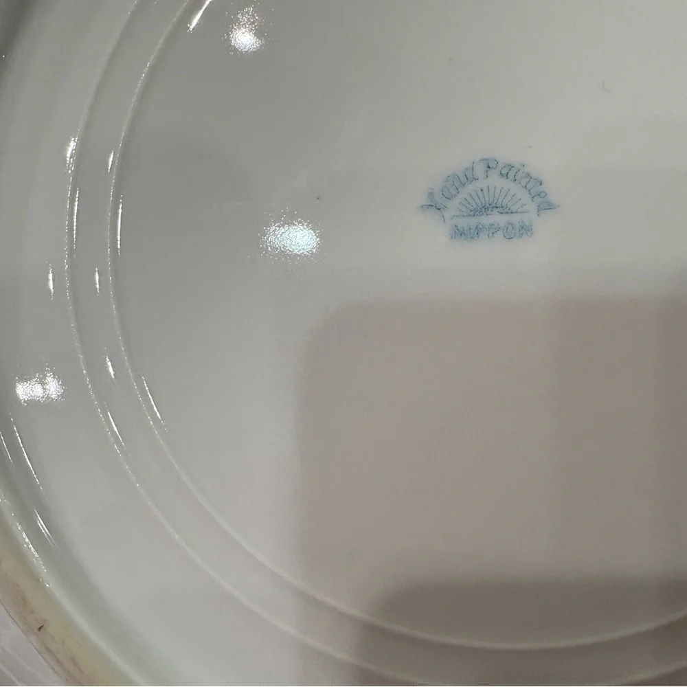 Nippon Hand-painted bowl featuring a floral motif & butterflies with gold trim
